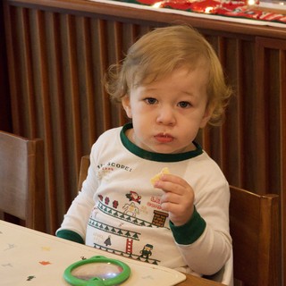 Toddler Enjoying Christmas Eve Snack at Home