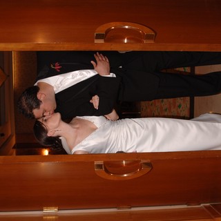 Newlyweds Share a Kiss in Elegant Doorway