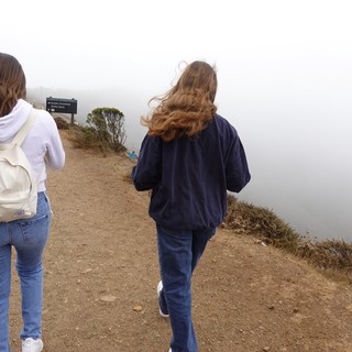 Two Women Walking in Coastal Fog