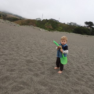 Barefoot Toddler Explores Foggy Pacific Beach