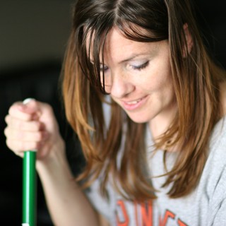 Smiling Woman Grips Green Handle with Delight