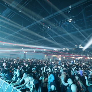 Massive Indoor EDM Festival Crowd Under Laser Light Show