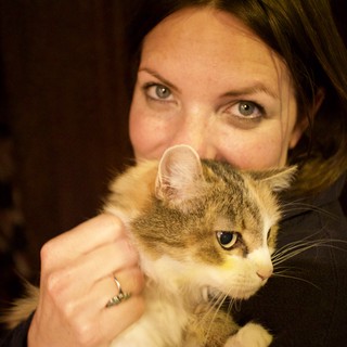 Woman and Her Fluffy Tabby Cat Share a Moment