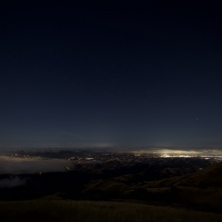 City Lights Glowing Beneath a Sea of Fog