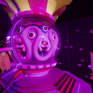 Surreal Purple-Lit Animatronic Rabbit Character in Dark Attraction