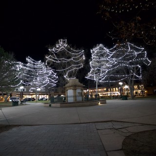 Illuminated Angel Wings Display in Town Square at Night
