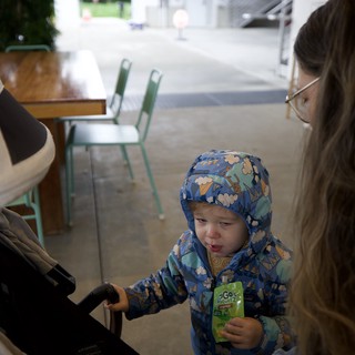 Young Child's First Restaurant Experience in Winter Coat