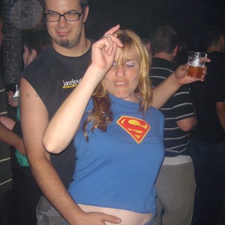 Couple Dancing at a Crowded Nightclub Party