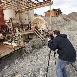 Man photographing a factory machine
