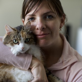 Woman and Calico Cat Share a Tender Moment