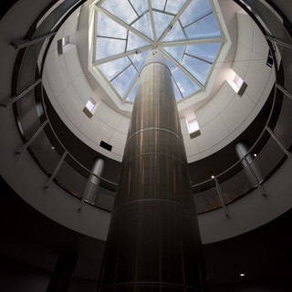 Skyward View Through Modern Cylindrical Glass Atrium
