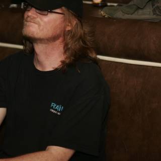 Black Shirted Man Relaxing on the Couch