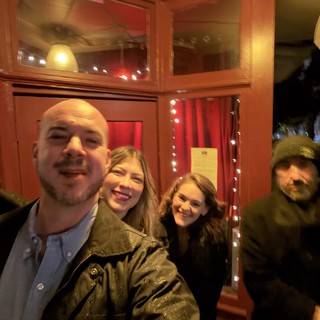 Friends Gathering at Cozy Restaurant Entrance