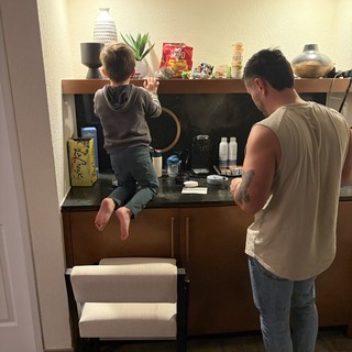 Father and Son Making Coffee Together in Modern Kitchen