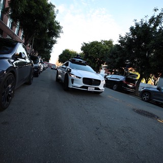 White Jaguar I-PACE on San Francisco Street at Dusk