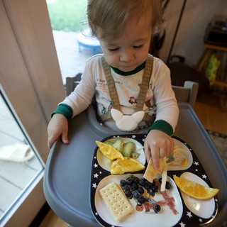 Toddler Enjoying Christmas Eve Breakfast at Home