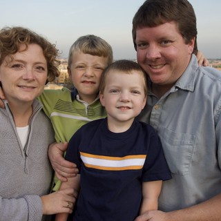 Happy Family Portrait on Rooftop at Dusk