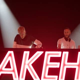 Two Men in front of Nakehip Neon Sign at Coachella