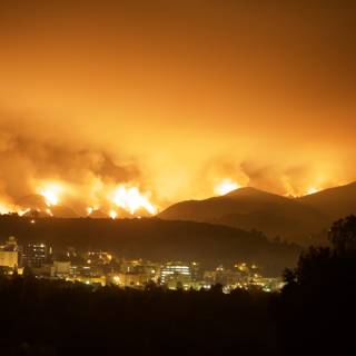 Flames Engulf Mountain and Cityscape