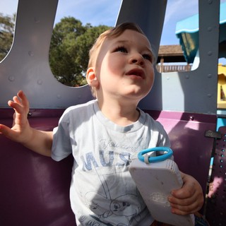 Joyful Toddler Playing at Colorful Playground