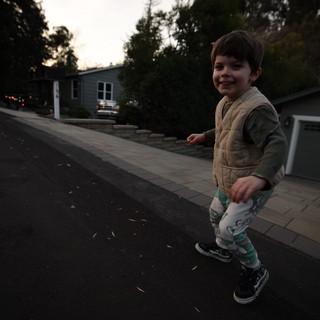 Young Boy Playing on Suburban Street at Dusk
