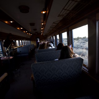 Scenic Train Journey Through Desert Landscape at Dusk