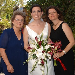 Bride Poses with Family at Garden Wedding