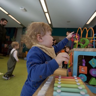 Toddler Engaged in Developmental Play at Activity Center