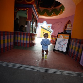 Toddler Exploring Whimsical Children's Play Area Entrance