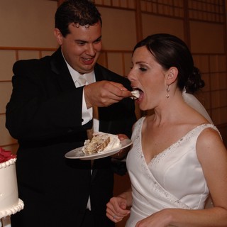Bride and Groom Share First Slice of Wedding Cake