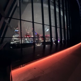 Night View of London Skyline Through Modern Glass Architecture