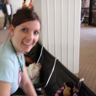 Smiling Woman With Stroller at Indoor Event