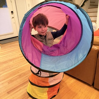 Child Playing in Colorful Pop-Up Tunnel Toy