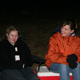Two Women Laughing at a Nighttime Campsite
