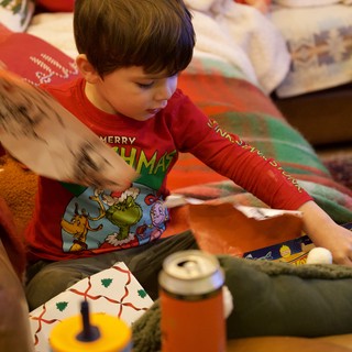 Child Opening Christmas Presents on Christmas Morning