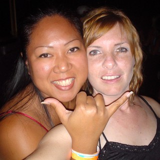 Two Friends Smiling at a Nightclub Party