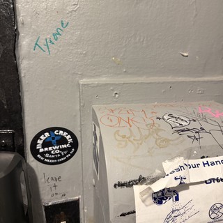 Graffiti and Stickers in Urban Bathroom Corner