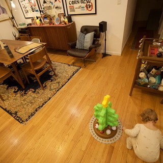 Child Playing with Toy Palm Tree in Mid-Century Modern Living Room