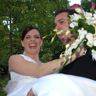 Joyful Bride Carried by Groom at Outdoor Wedding