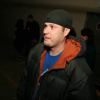 Fashionable Man in Black Jacket and Blue Hat