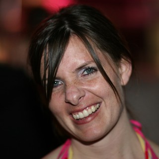 Radiant Smile at a Vibrant Evening Gathering