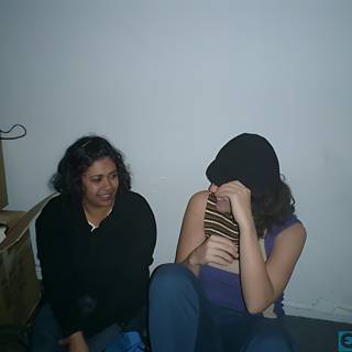 Two Women Sitting with Cardboard Boxes