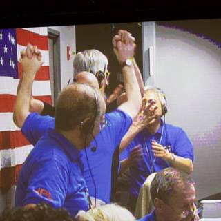 Blue-clad Group Proudly Waves American Flag