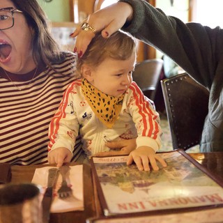 Joyful Family Moment During Child's First Haircut