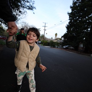 Joyful Child Walking Hand-in-Hand at Dusk