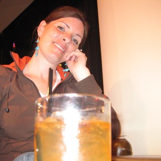 Smiling Woman Relaxing with Drinks After Hike