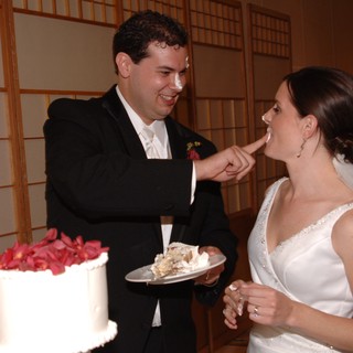 Bride and Groom Share Playful Wedding Cake Moment