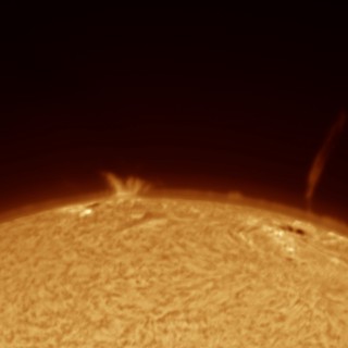Solar Surge Prominence and Jet Over Sun's Limb