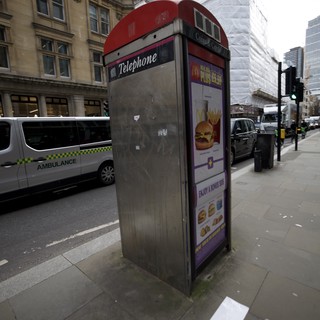 Traditional Red Telephone Box with McDonald's Advertisement in London