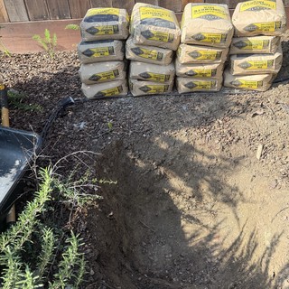 Sakrete Concrete Mix Bags Stacked for Backyard Project